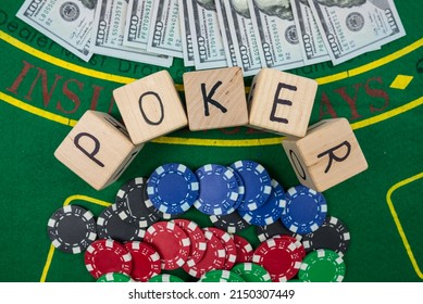 Word Pokerr On Wooden Dice. Poker Chips And Dollars On A Green Poker Table. View From Above.gambling