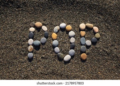 Word Pop Made From Stones On Sandy Beach. Popular Culture Concept