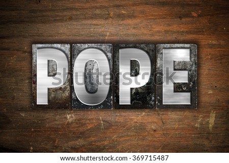 The word "Pope" written in vintage metal letterpress type on an aged wooden background.