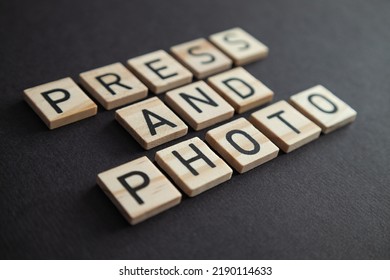 The Word PRESS AND PHOTO, Written In Black Letters On Wooden Blocks, Lay Flat.
