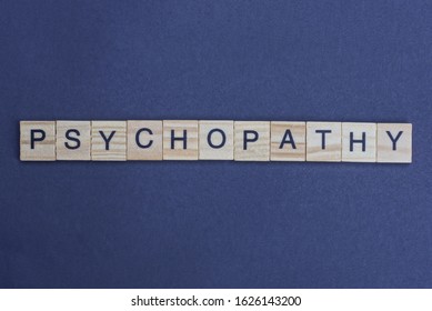 Word Psychopathy Made From Wooden Letters Lies On A Gray Table