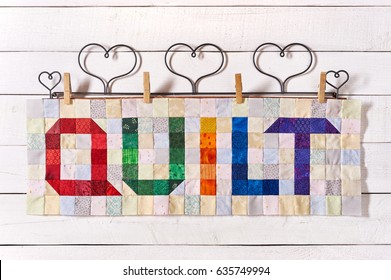 The Word Quilt Sewn From Colorful Square And Triangle Pieces Of Fabric