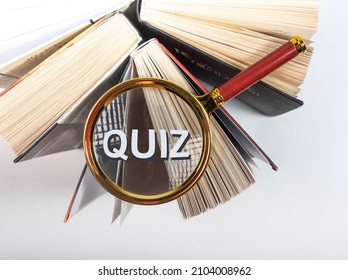 Word Quiz Through Magnifying Glass On Books.