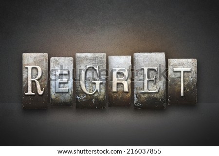 The word REGRET written in vintage letterpress type