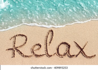 Word Relax Handwritten On Sandy Beach