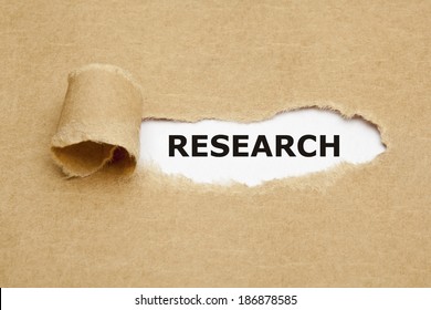 The Word Research Appearing Behind Torn Brown Paper.