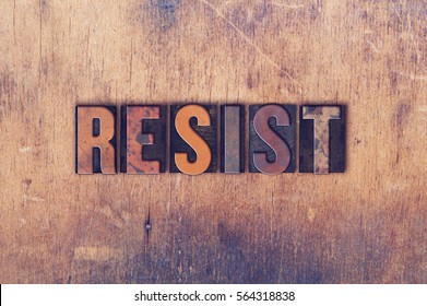 The word "RESIST" written in vintage wooden letterpress type.
