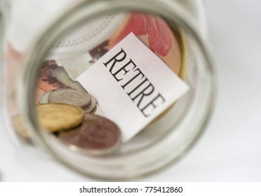 The Word Retire Is Shown In A Mason Jar With Canadian Coins And A Fifty Dollar Bill