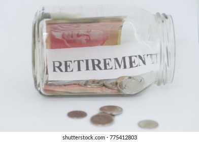 The Word Retirement Is Shown In A Mason Jar With Canadian Coins And A Fifty Dollar Bill