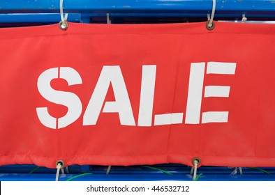 Word Sale Painted With White On Red Fabric Banner