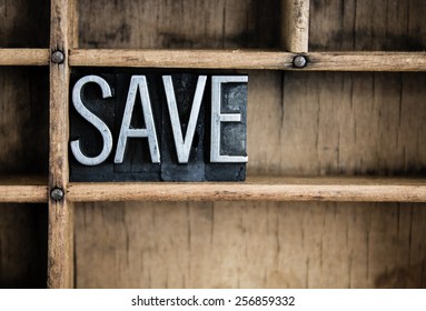 The word "SAVE" written in vintage metal letterpress type in a wooden drawer with dividers. - Shutterstock ID 256859332