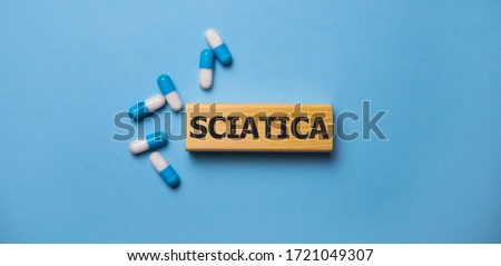 the word sciatica on wooden block. Medical concept