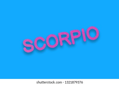 Word Scorpio Cut Out Of Purple Paper On Blue Table. Top View. Horoscope Concept