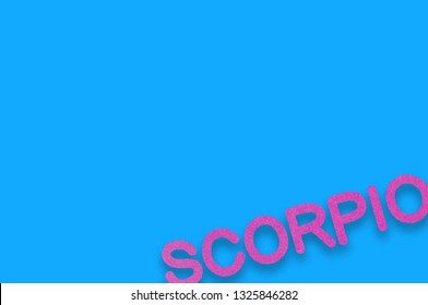 Word Scorpio Cut Out Of Purple Paper On Blue Table. Top View. Horoscope Concept