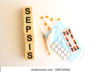 The word SEPSIS is made of wooden cubes on a white background. Medical concept.