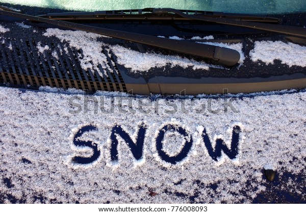 The word snow on a front\
of the car