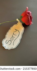 the word SORRY and a bouquet of roses on a white background. flowers and writing sorry as a symbol of apology