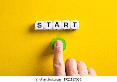 The Word Start On Cubes With A Male Hand Pressing The Start Button. To Make A New Start In Life, Business, Education Or Career Concept.