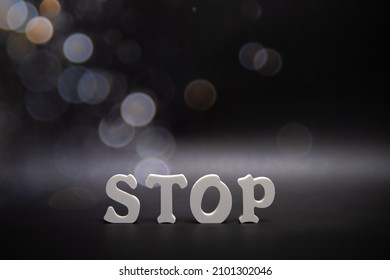 Word Stop on dark backround with bokeh Copy space. Banner.
