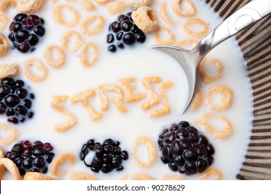 The word STRESS spelled out of alphabet cereal pieces floating in milk.