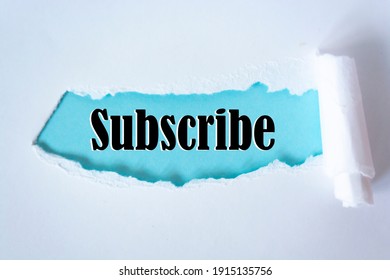 The word subscribe appearing behind torn paper