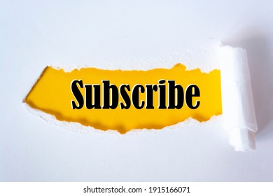 The word subscribe appearing behind torn paper