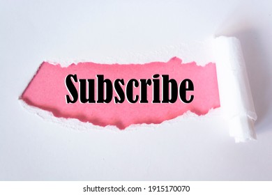 The word subscribe appearing behind torn paper
