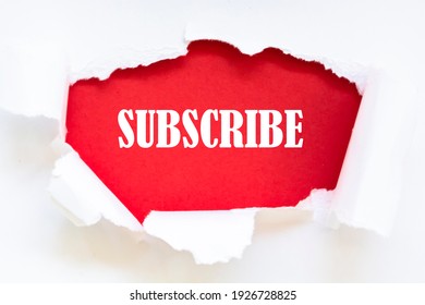 The word SUBSCRIBE appearing behind torn paper