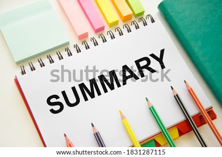 word summary written on notepad with markers and pencils. a summary of the material. . High quality photo