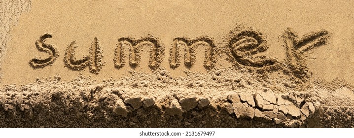 The word summer written in letters on the wet yellow sand, the inscription on the beach shoreline.