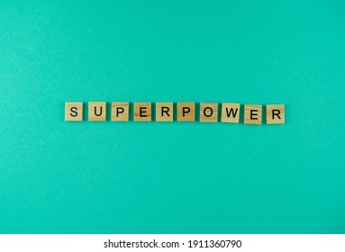 Word Superpower. The Phrase Is Laid Out In Wooden Letters. Top View. Motivation. Blue Background. Copy Space.