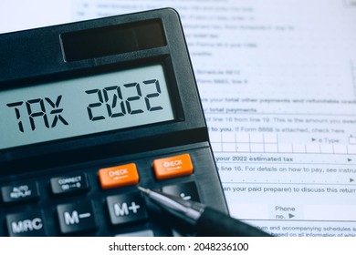 Word Tax 2022 on the calculator on documents.Income Statement. paying the tax rate. Taxation, taxes burden.Business and tax concept.