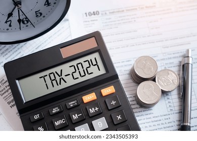 Word Tax 2024 on the calculator on documents.Income Statement. paying the tax rate. Taxation, taxes burden.Business and tax concept.
