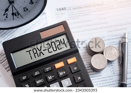 Word Tax 2024 on the calculator on documents.Income Statement. paying the tax rate. Taxation, taxes burden.Business and tax concept.