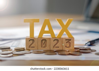 The word TAX is on a wooden block, 2023 is below. Income tax payment concept.  Return of personal income tax payable to the government  Calculation of tax returns in the years 2022 to 2023, etc. - Shutterstock ID 2230063611