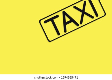 Word Taxi In Frame Of Black Color Cut Out Of Black Paper On Yellow Background. Top View. Concept Of Journey. Copy Space