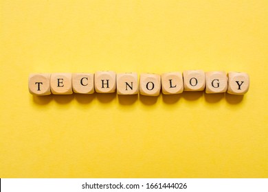 the word Technology, text made with dice on yellow background