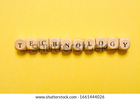 the word Technology, text made with dice on yellow background