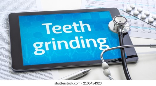 The word Teeth grinding on the display of a tablet
