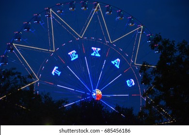 The Word Texas On A Ferris Wheel In A Dallas Park And Events Ground.