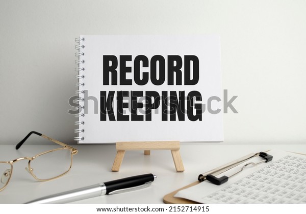 Word text RECORD KEEPING on white paper card\
business concept