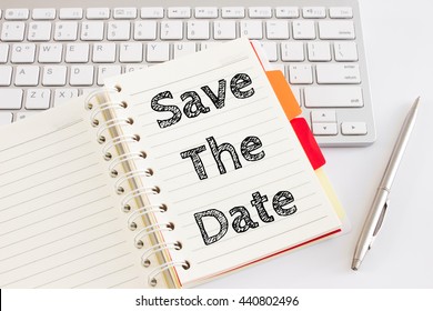 Word Text Save The Date On White Paper On Office Table / Business Concept