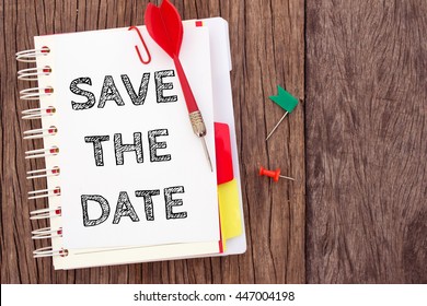 Word Text Save The Date On White Paper Card With Wood Table / Business Concept