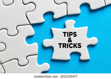 The Word Tips And Tricks On A Puzzle Piece. Business Concept For Suggestion, Solutions And Helpful Advices.