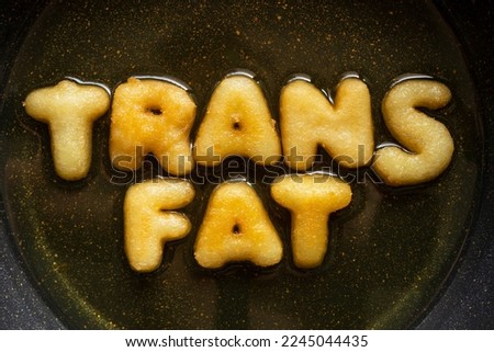 word TRANS FAT made from french fries in frying pan. health food concept Foto stock © 