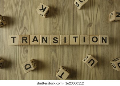 Word Transition From Wooden Blocks On Desk, Development Concept