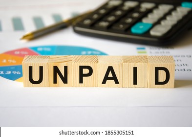  The word UNPAID is written on a block of wood. UNPAID text on wooden cubes calculator in the background for your design, concept. High quality photo - Shutterstock ID 1855305151
