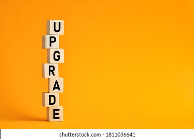 The Word Upgrade On Wooden Cubes Against Yellow Background. Computer, Network, Internet Business Technology Upgrade Concept.