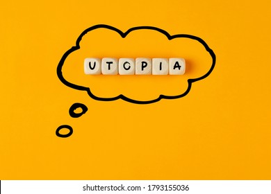 The Word Utopia Written On Wooden Cubes Framed With A Thought Bubble. Concept Of Thinking Or Dreaming Of An Utopia.