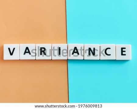 The word variance is composed of square letter tiles on a orange and blue background.